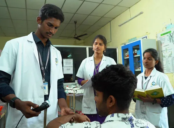Physiotherapy laboratory with students following lab safety guidelines and hands-on clinical practice at Cheran College of Physiotherapy, Coimbatore.
